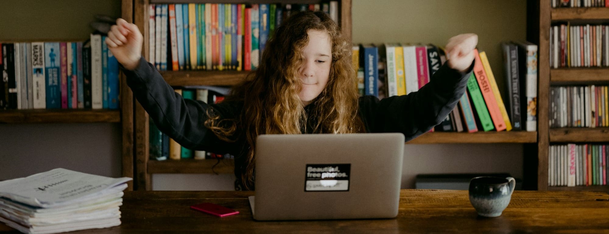 woman in black long sleeve shirt sitting in front of silver macbook